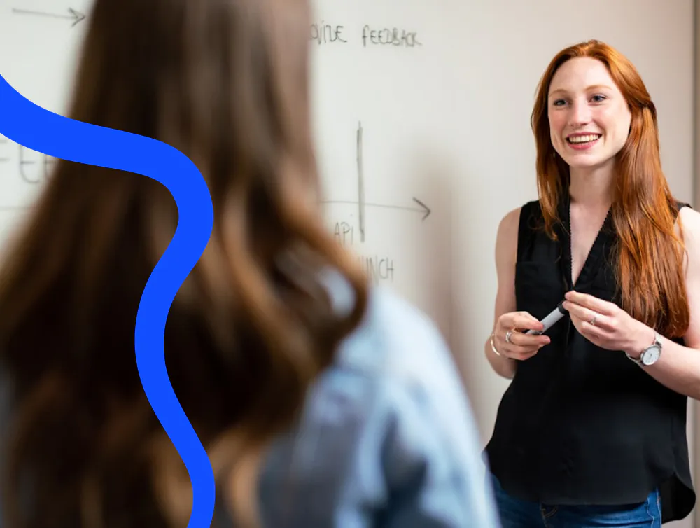 A colleague at a whiteboard talking a team through where their time goes