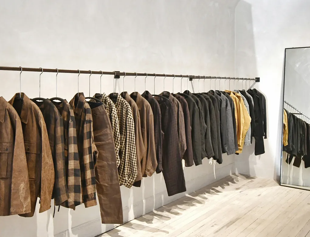 Clothing on a rail in a minimal retail store