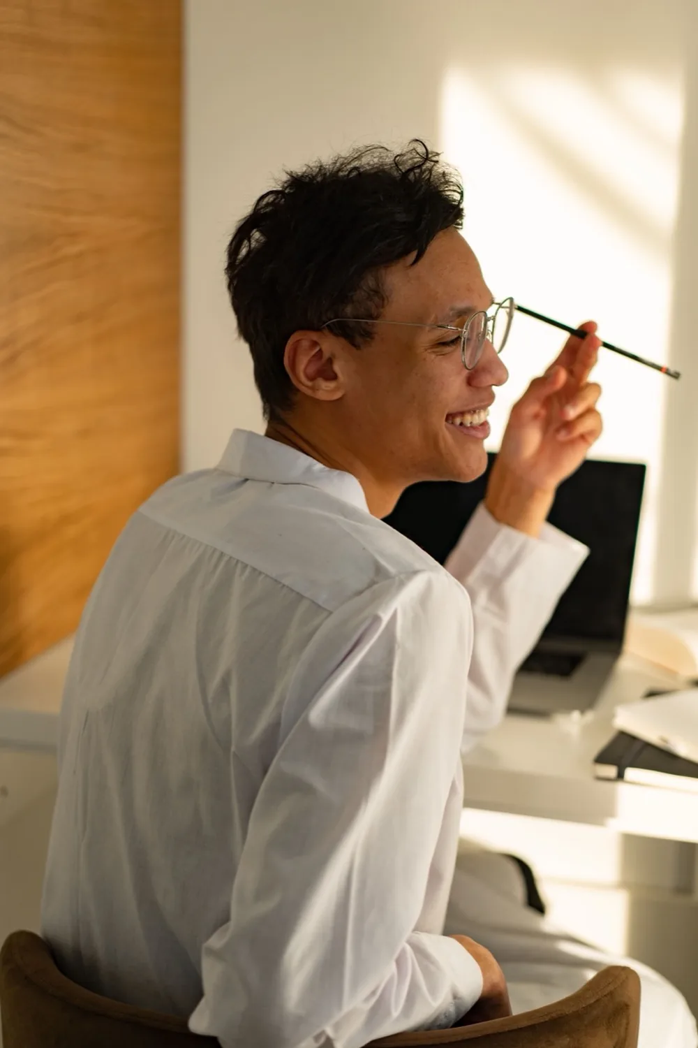 A sales rep at their desk, thinking during a call