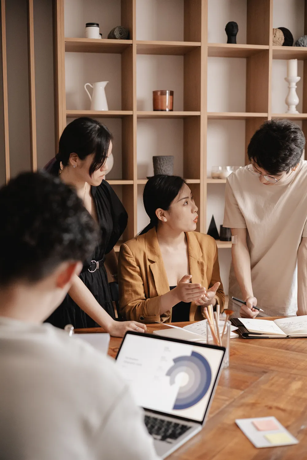 A team reviewing results together around a laptop